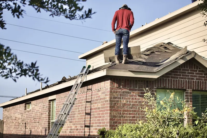 Professional roofer working on a residential roof in Runnymeade Farms